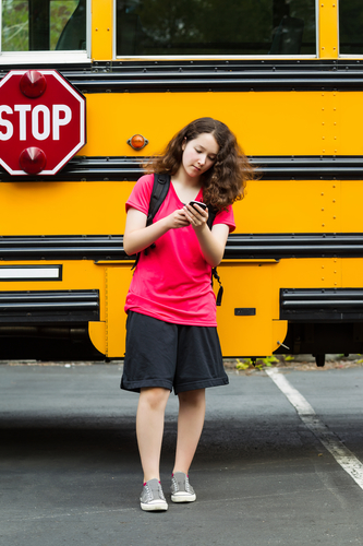 Example of Digital Divide: Girl doing homework with school bus wifi